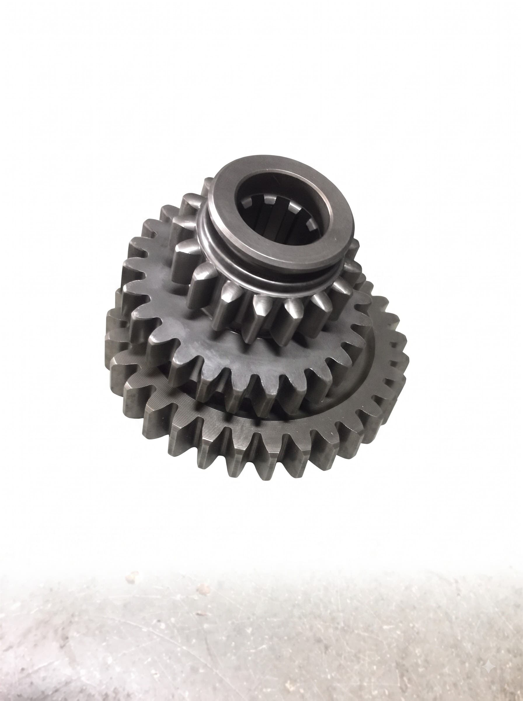 Compound Transmission Gear — a splined double-gear cluster from a transmission gear train, machined for a keyed shaft fit.