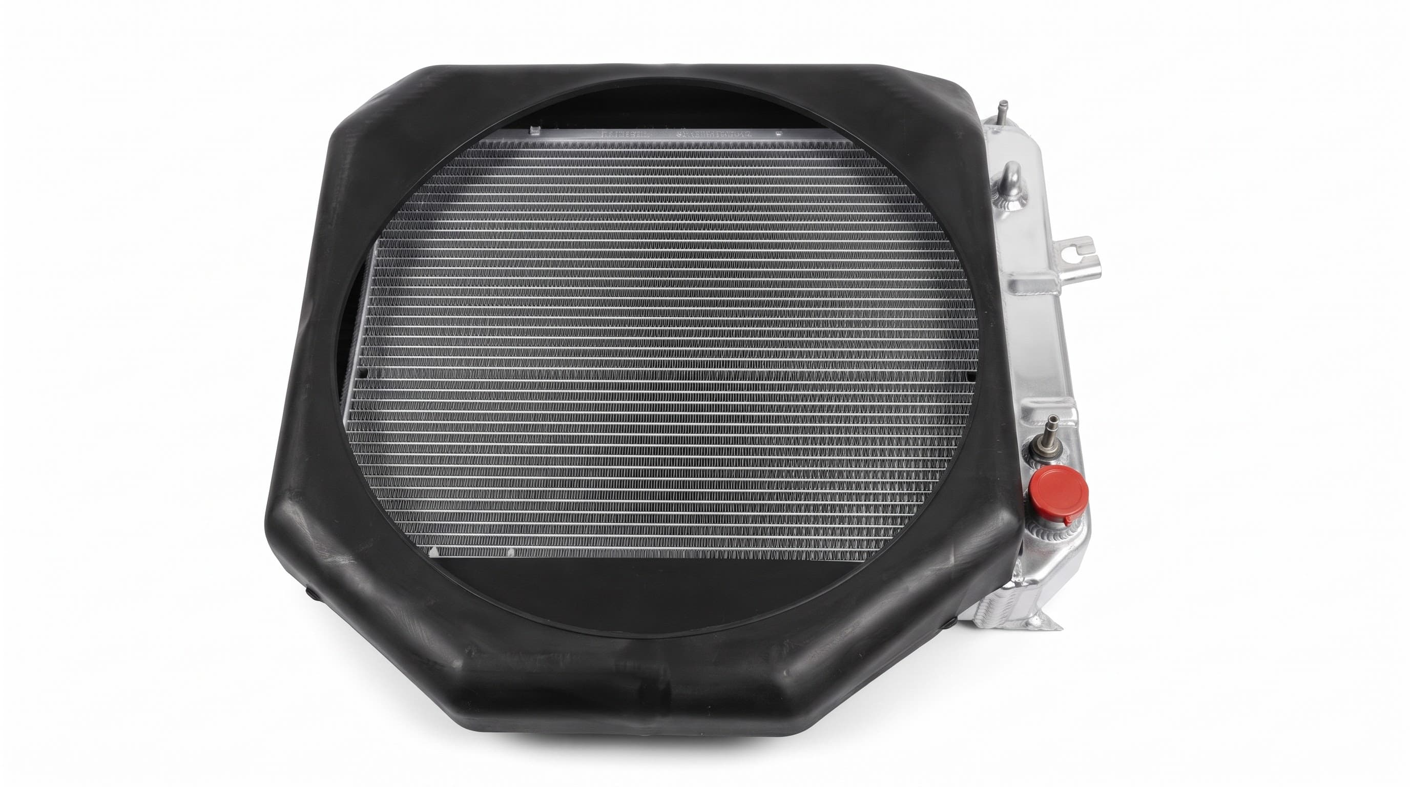 A second radiator fitment, aluminium core with a rubber shroud gasket and pressure cap.